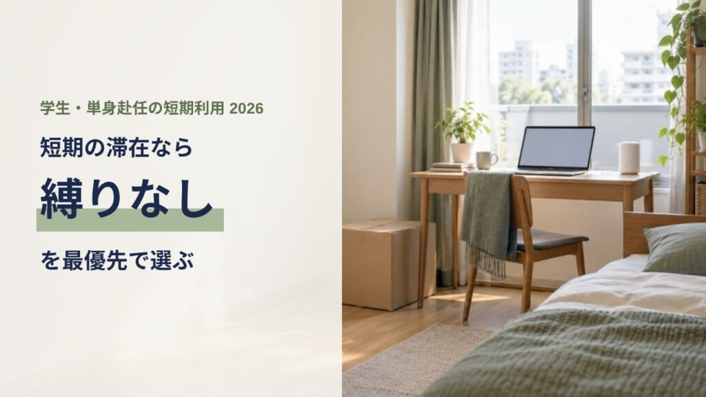 短期滞在のワンルームの窓際デスクにノートパソコンと小型の通信機器が置かれている